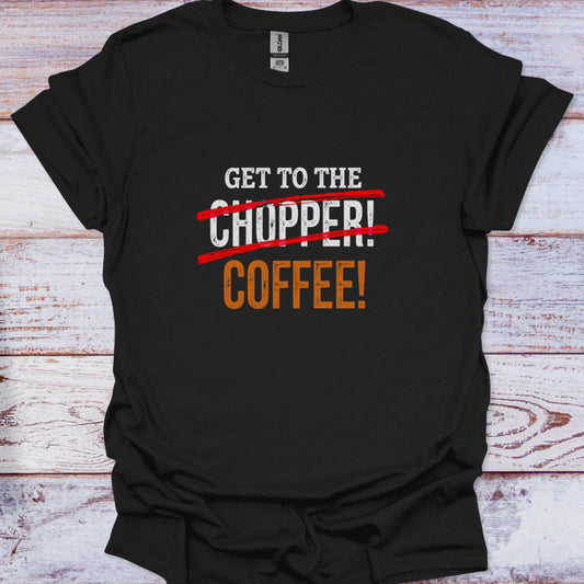 Black t-shirt with humorous text design on a wooden surface