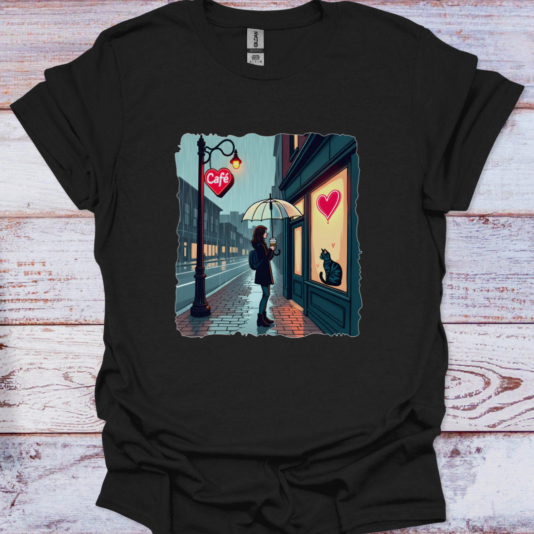 Black t-shirt with a graphic of a person with an umbrella standing outside a cafe with a heart on the door.