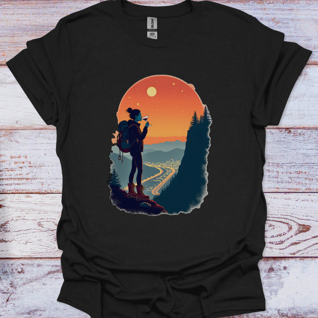 Black t-shirt with a graphic of a hiker and sunset design on a wooden surface