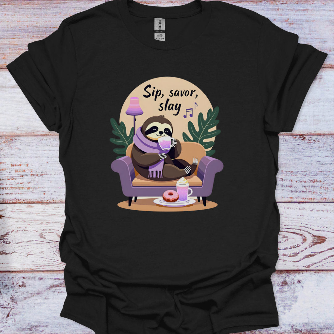 Black t-shirt with a sloth graphic and 'Sip, savor, slay' text on a wooden surface