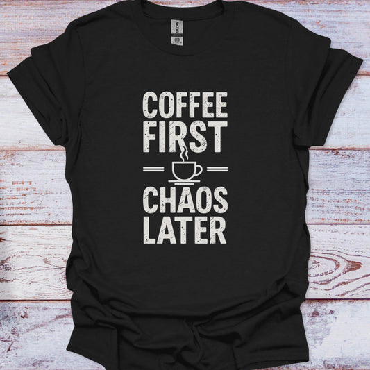 Black t-shirt with 'Coffee First, Chaos Later' text on a wooden surface