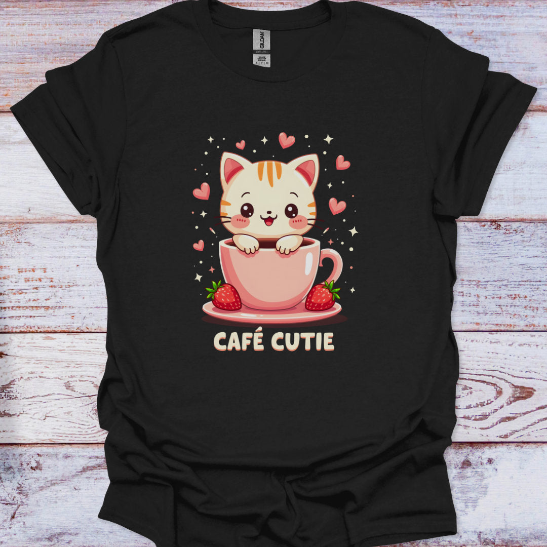 Black t-shirt with a cute cat design in a pink cup on a wooden surface