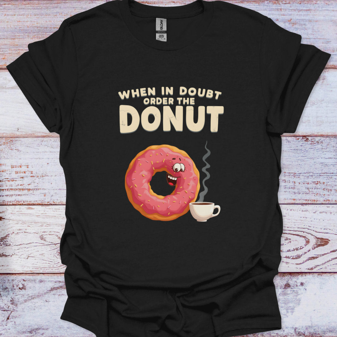 Black t-shirt with a cartoon donut and coffee cup graphic and text 'When in Doubt, Order the Donut' on a wooden surface.