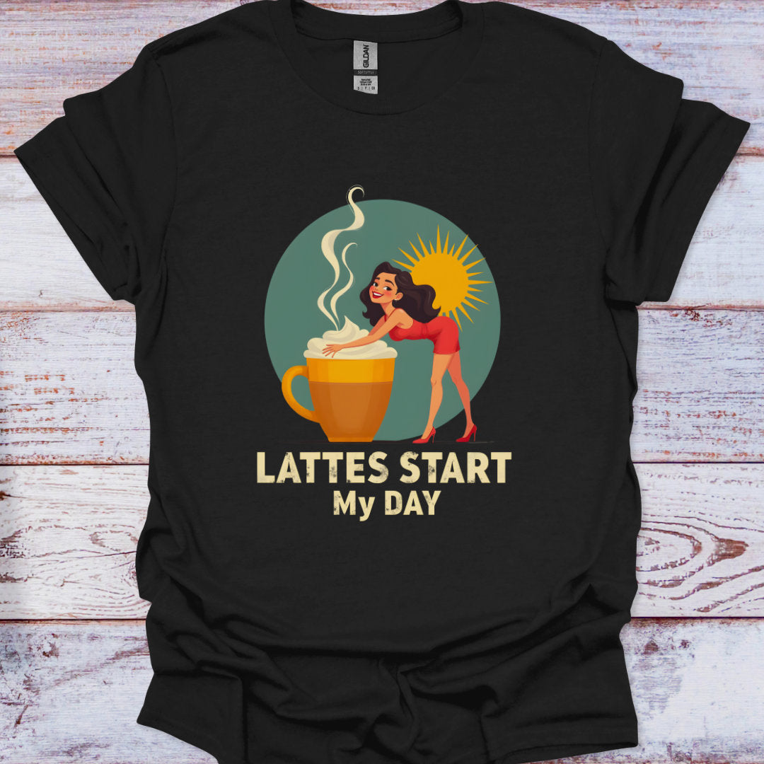Black t-shirt with a graphic of a woman by a coffee cup and text 'Lattes Start My Day' on a wooden surface.
