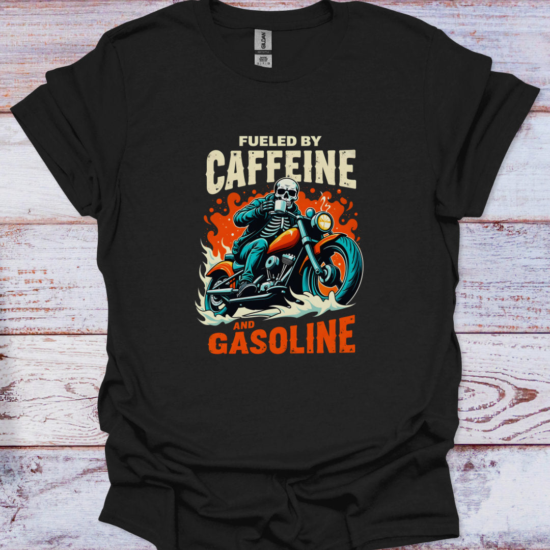 Black t-shirt with a graphic design of a skeleton on a motorcycle and text 'Fueled by Caffeine and Gasoline' on a wooden surface.