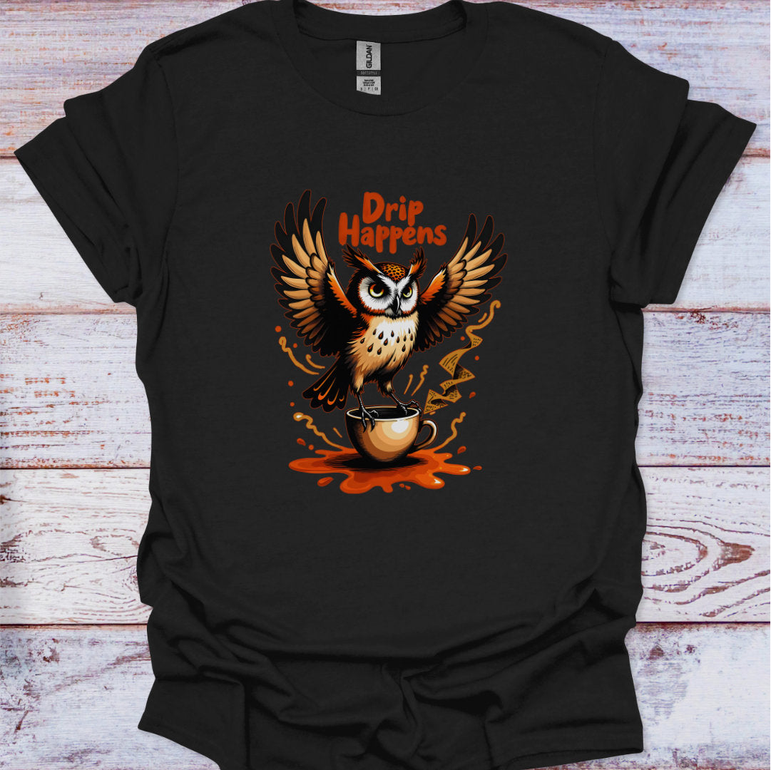 Black t-shirt with an owl holding a coffee cup and 'Drip Happens' text on a wooden surface