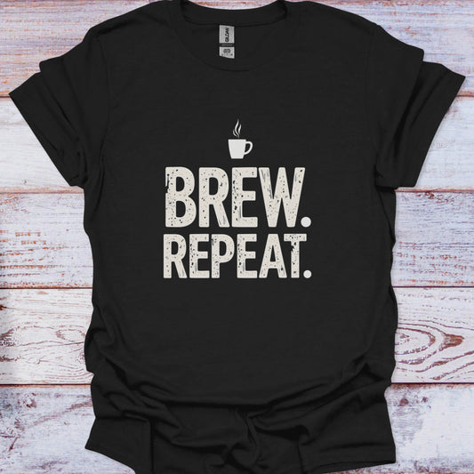 Black t-shirt with 'Brew. Repeat.' text and coffee cup graphic on a wooden surface
