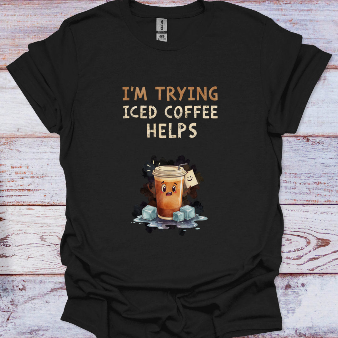 Black t-shirt with 'I'm Trying Iced Coffee Helps' text and graphic on a wooden surface