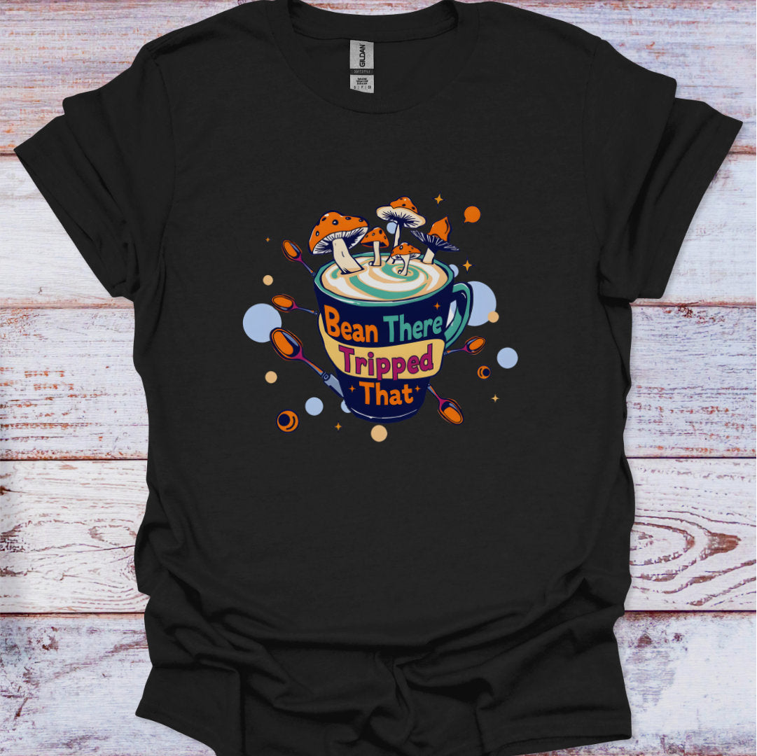 Black t-shirt with a colorful graphic design on a wooden surface