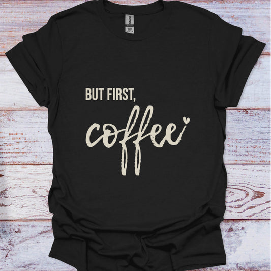 Black t-shirt with 'But first, coffee' text on a wooden surface