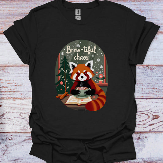 Black t-shirt with a red panda holding a cup of coffee and 'Brew-tiful chaos' text on a wooden surface.