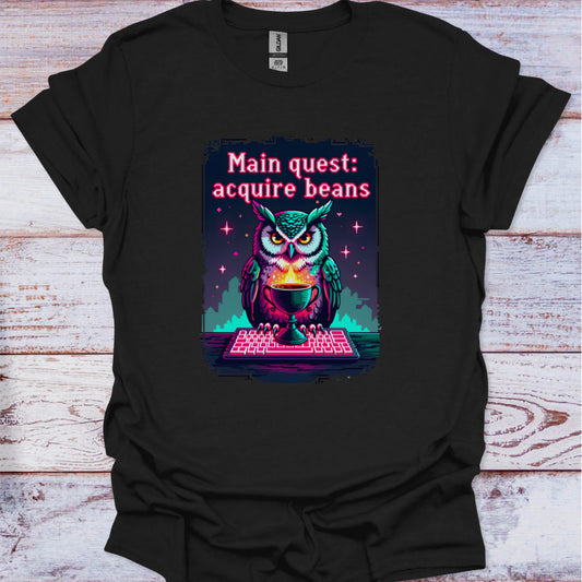 Black t-shirt with an owl graphic and text on a wooden surface