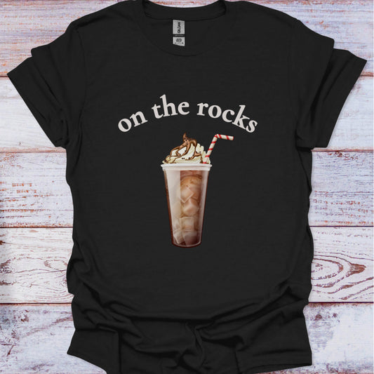 Black t-shirt with a graphic of an iced coffee and text 'on the rocks' on a wooden surface.
