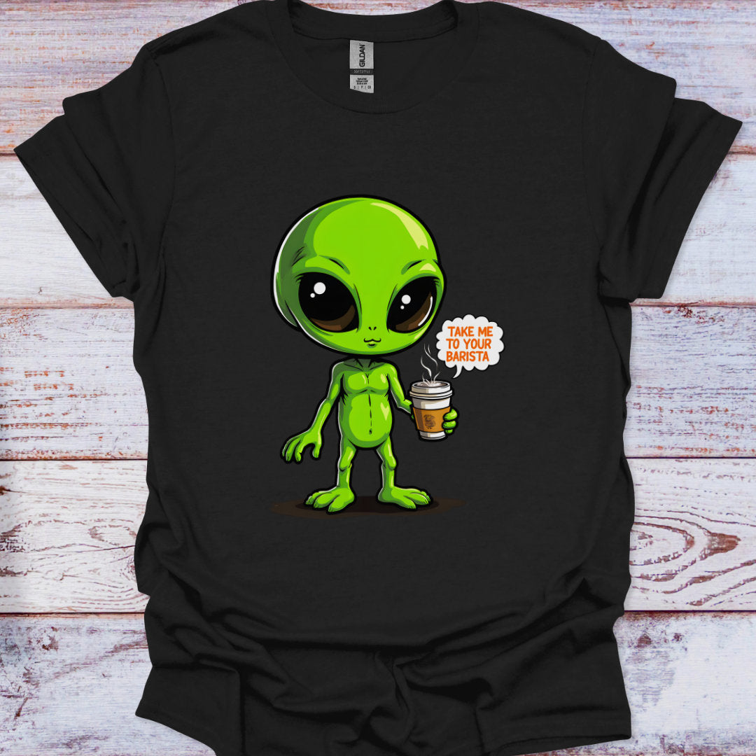 Black t-shirt with a green alien holding a coffee cup graphic on a wooden surface