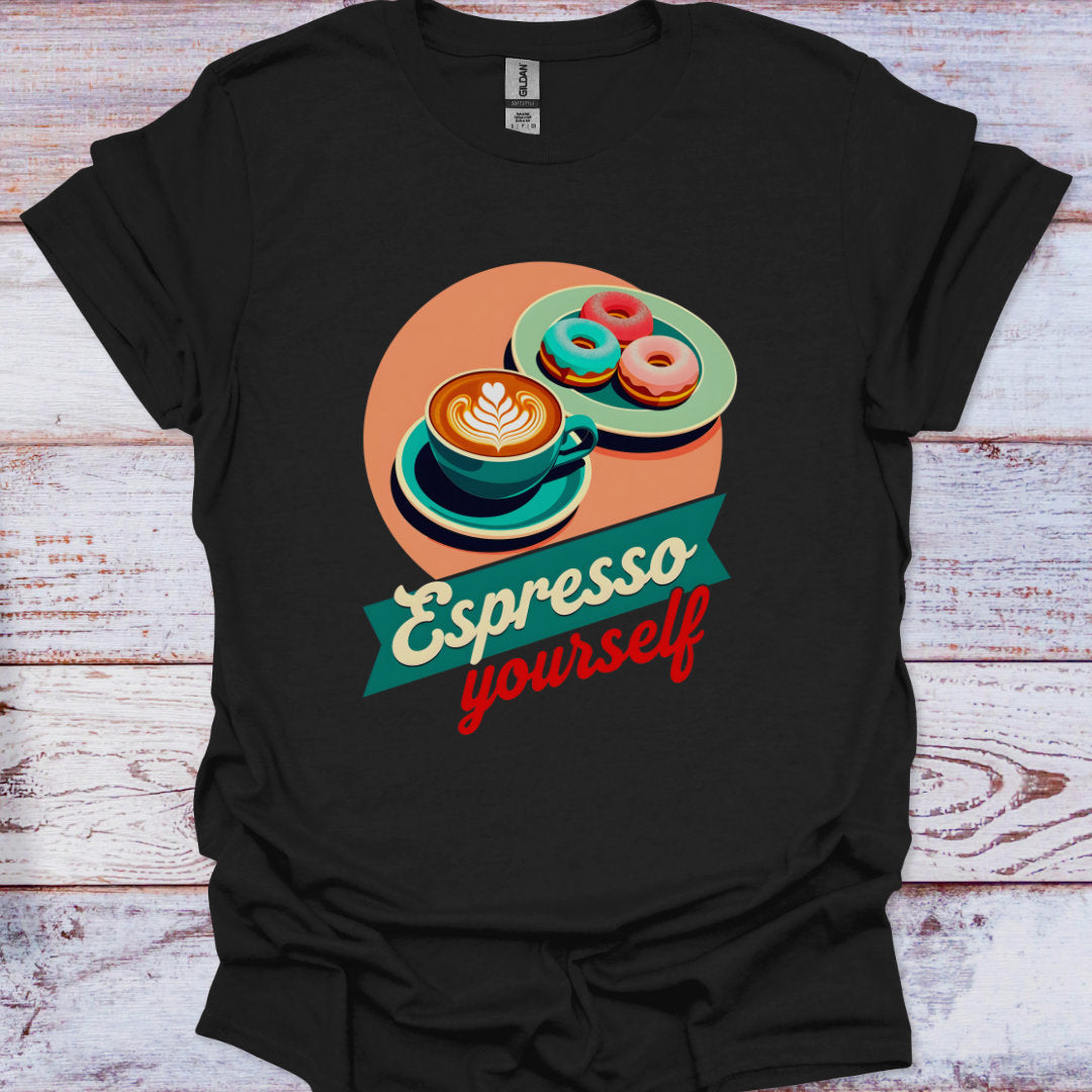 Black t-shirt with a colorful coffee and donuts graphic and 'Espresso yourself' text on a wooden surface.