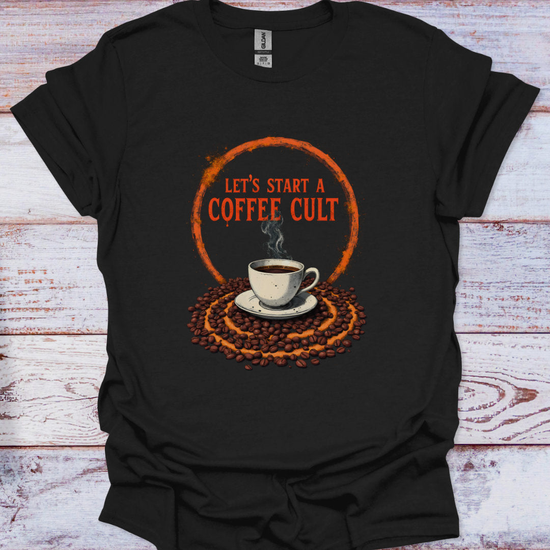 Black t-shirt with a coffee-themed graphic and text on a wooden surface