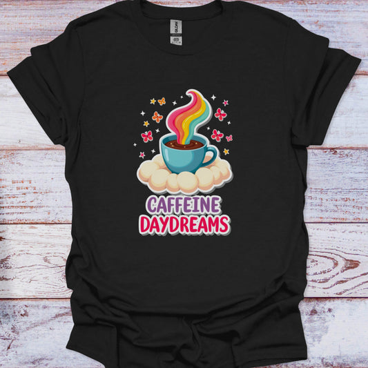 Black t-shirt with a colorful coffee cup graphic and 'Caffeine Daydreams' text on a wooden surface.