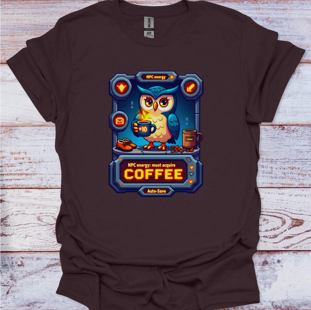 Brown t-shirt with a graphic of an owl holding a coffee cup on a wooden surface