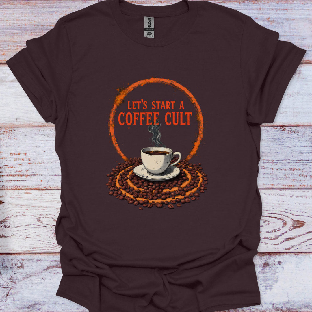 Brown t-shirt with coffee-themed graphic and text 'Let's Start a Coffee Cult' on a wooden surface.
