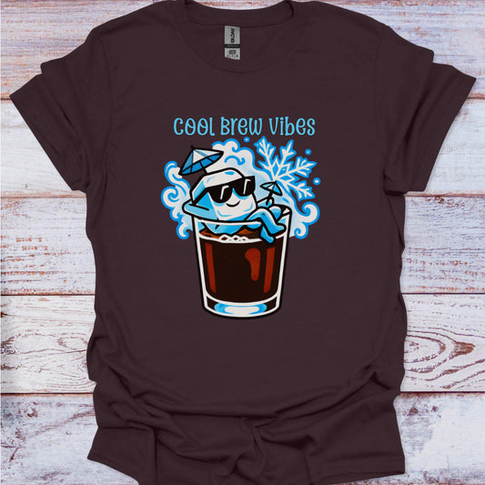 Brown t-shirt with 'Cool Brew Vibes' graphic design on a wooden surface