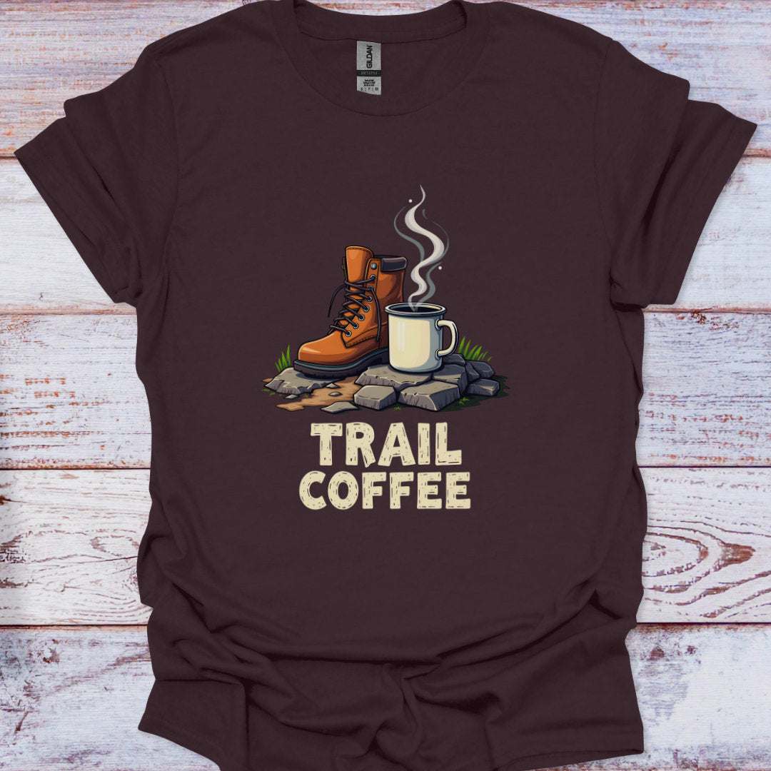Brown t-shirt with 'Trail Coffee' graphic featuring boots and a mug on a wooden background