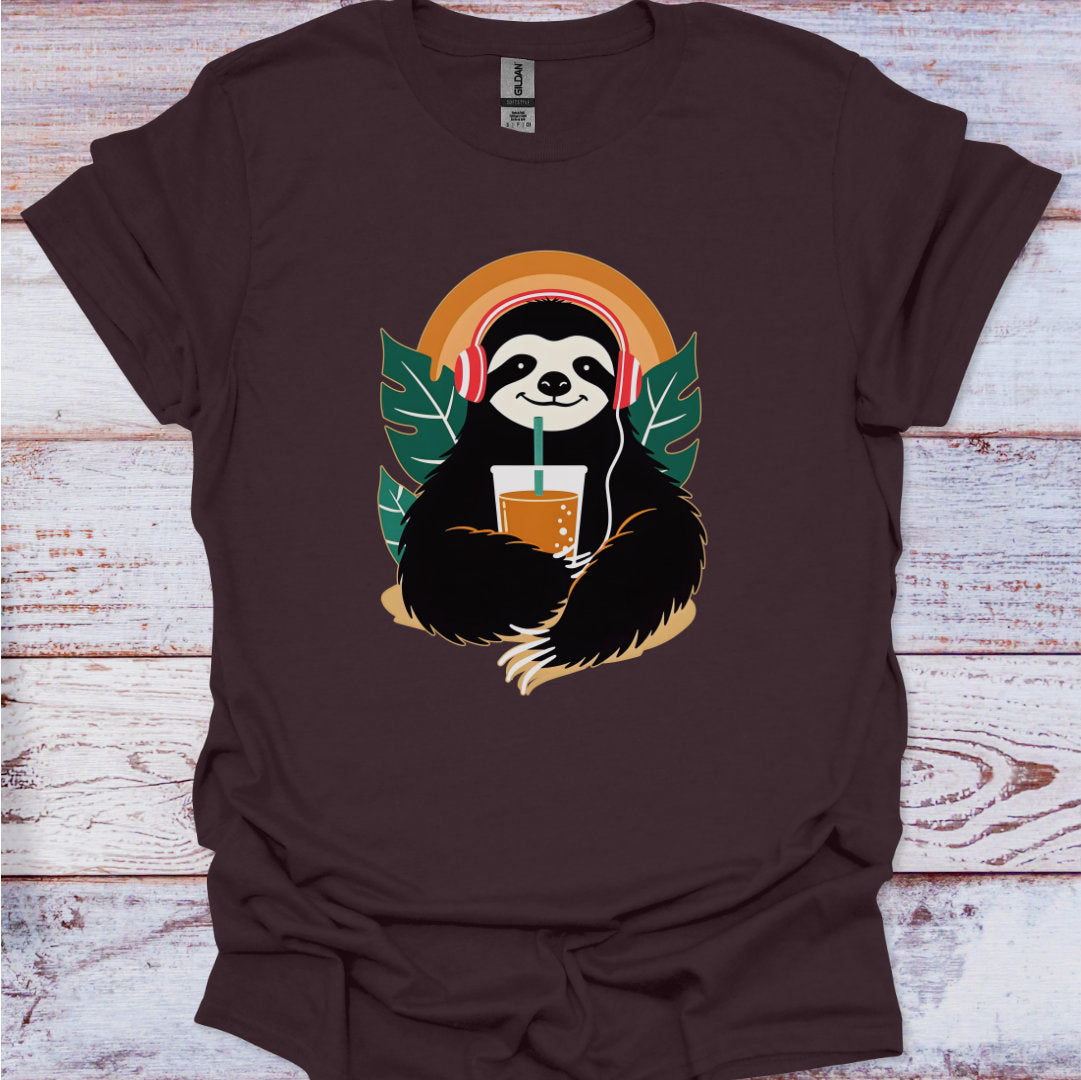 Brown t-shirt with a sloth holding a drink graphic on a wooden surface