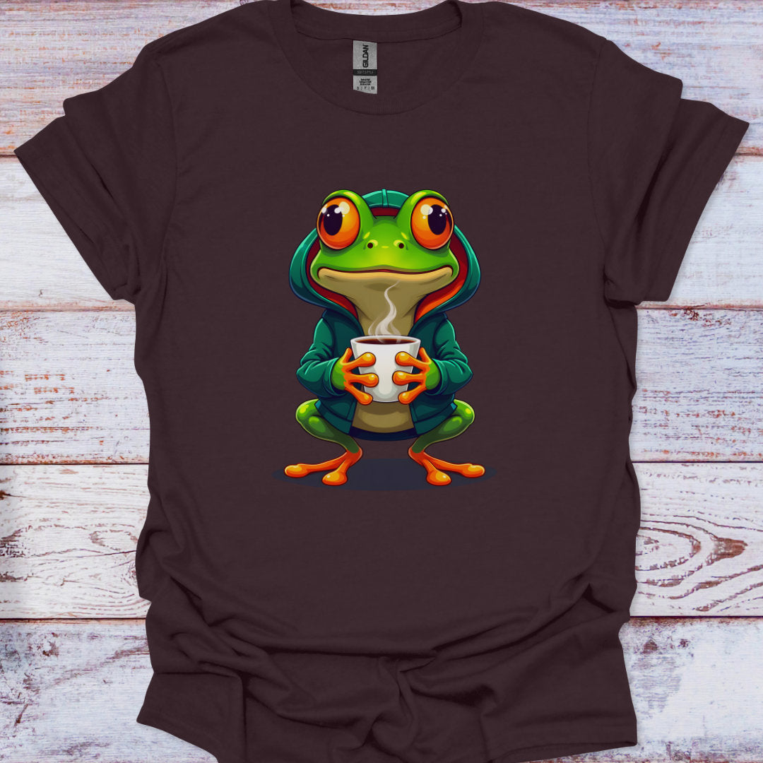 Brown t-shirt with a green frog holding a cup design on a wooden surface