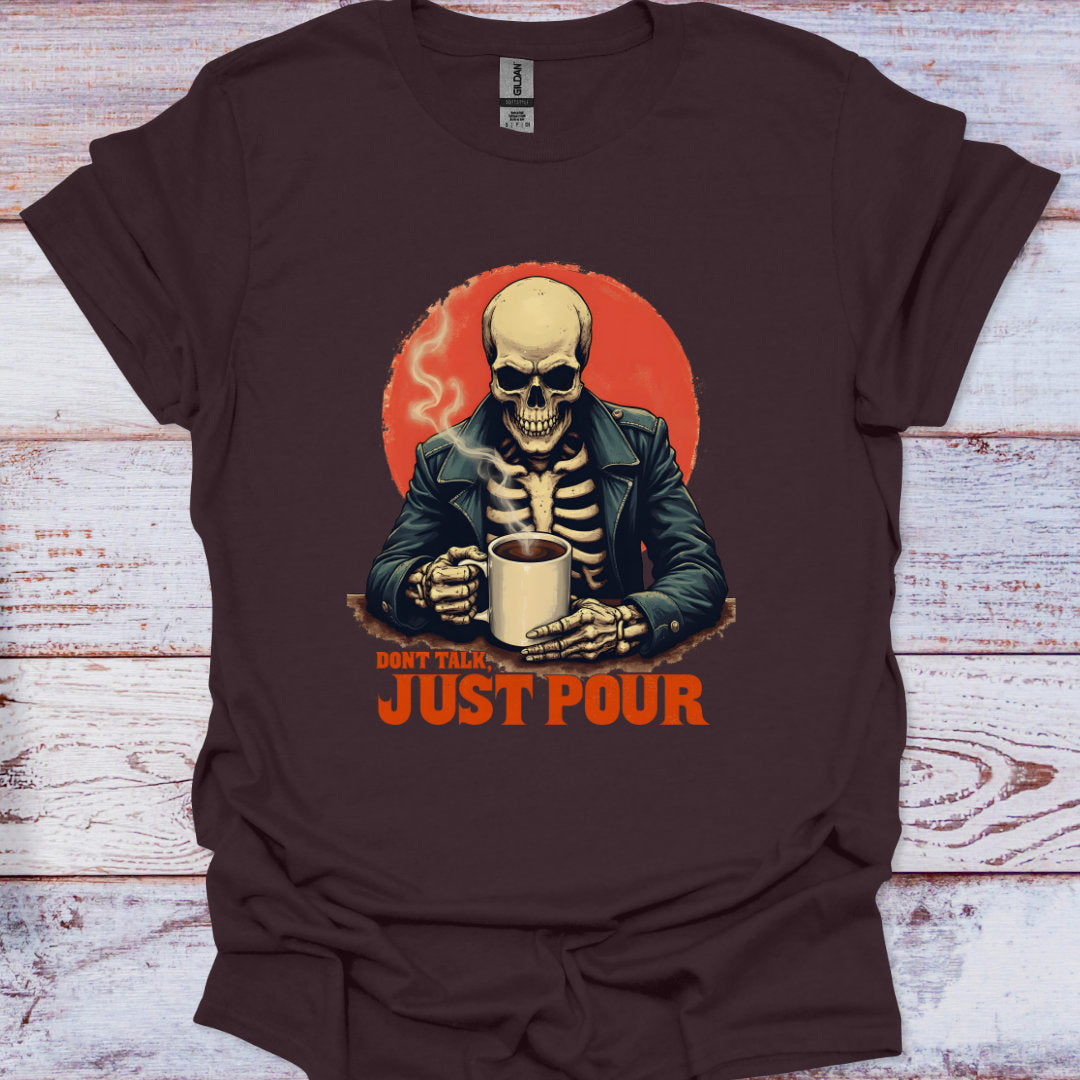 Brown t-shirt with a skeleton holding a cup and 'Don't Talk Just Pour' text on a wooden surface