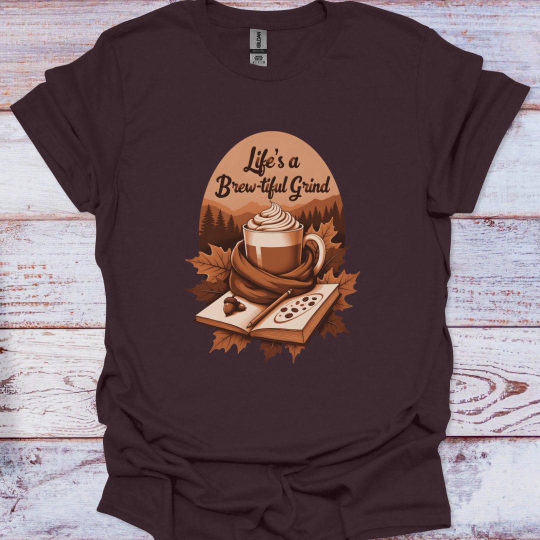 Brown t-shirt with a coffee cup graphic and 'Life's a Brew-tiful Grind' text on a wooden surface