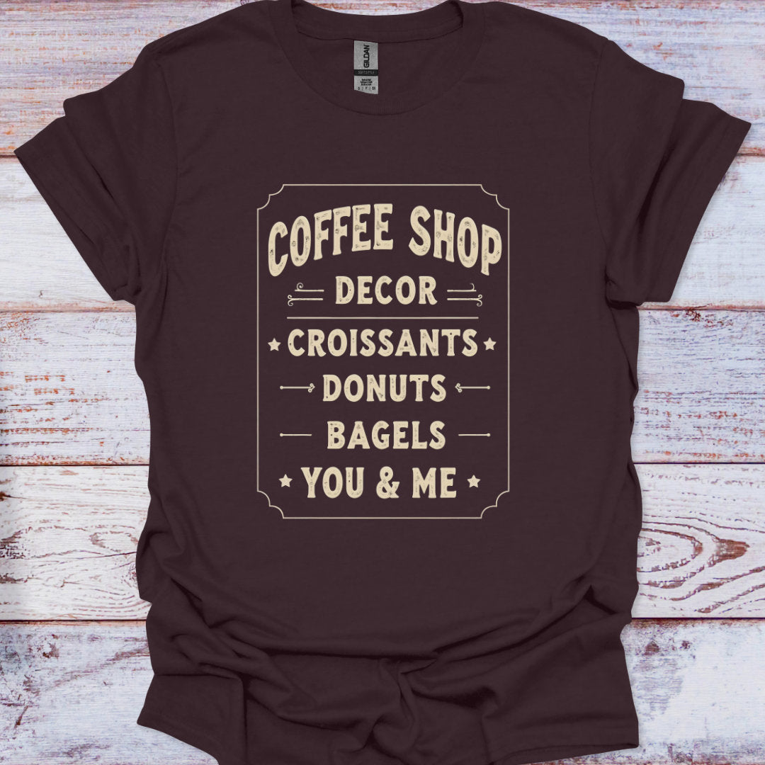 Brown t-shirt with white text on a wooden surface