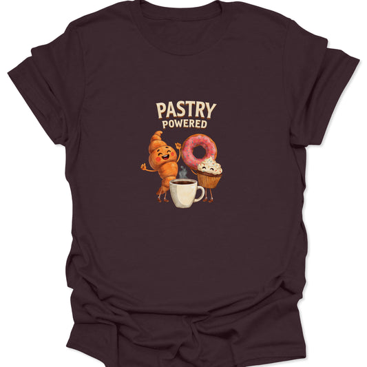 Dark brown apparel graphic tee showing funny anthropomorphic pastry characters cheering next to a white coffee mug for a caffeine energy boost, ideal for bakers and coffee addicts.