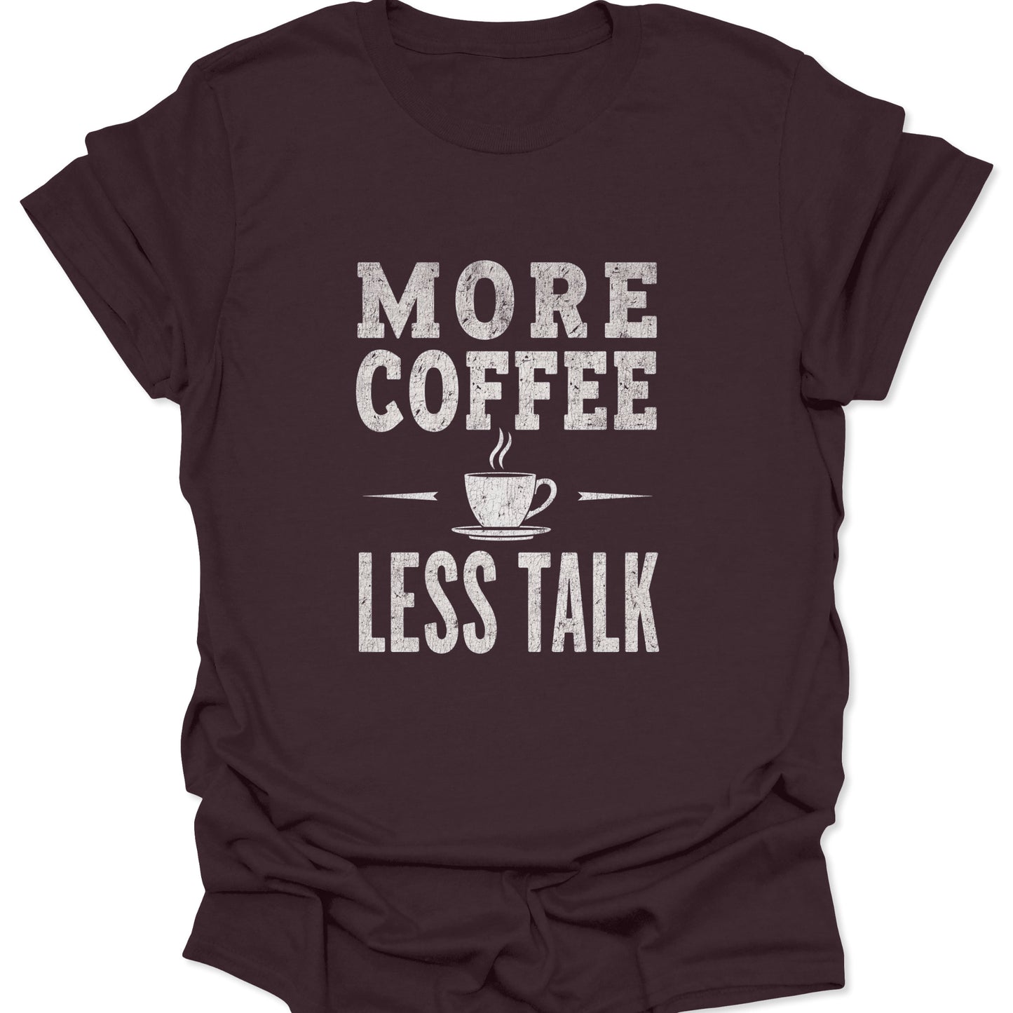 Dark brown t-shirt featuring a central white typographic graphic demanding 'MORE COFFEE LESS TALK' with a small, stylized steam cup illustration.