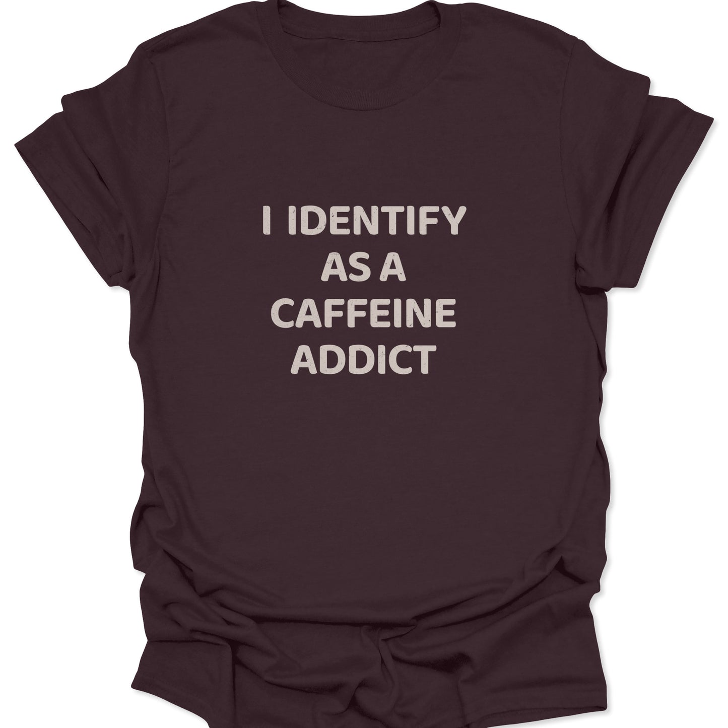 A dark chocolate brown t-shirt showcasing white weathered text that reads "I IDENTIFY AS A CAFFEINE ADDICT."