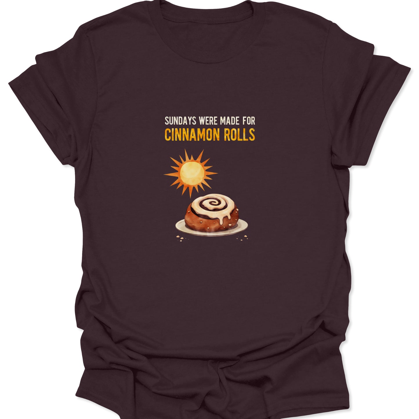 Dark chocolate brown tee with a vintage style illustration of a glazed cinnamon bun and sun rays.