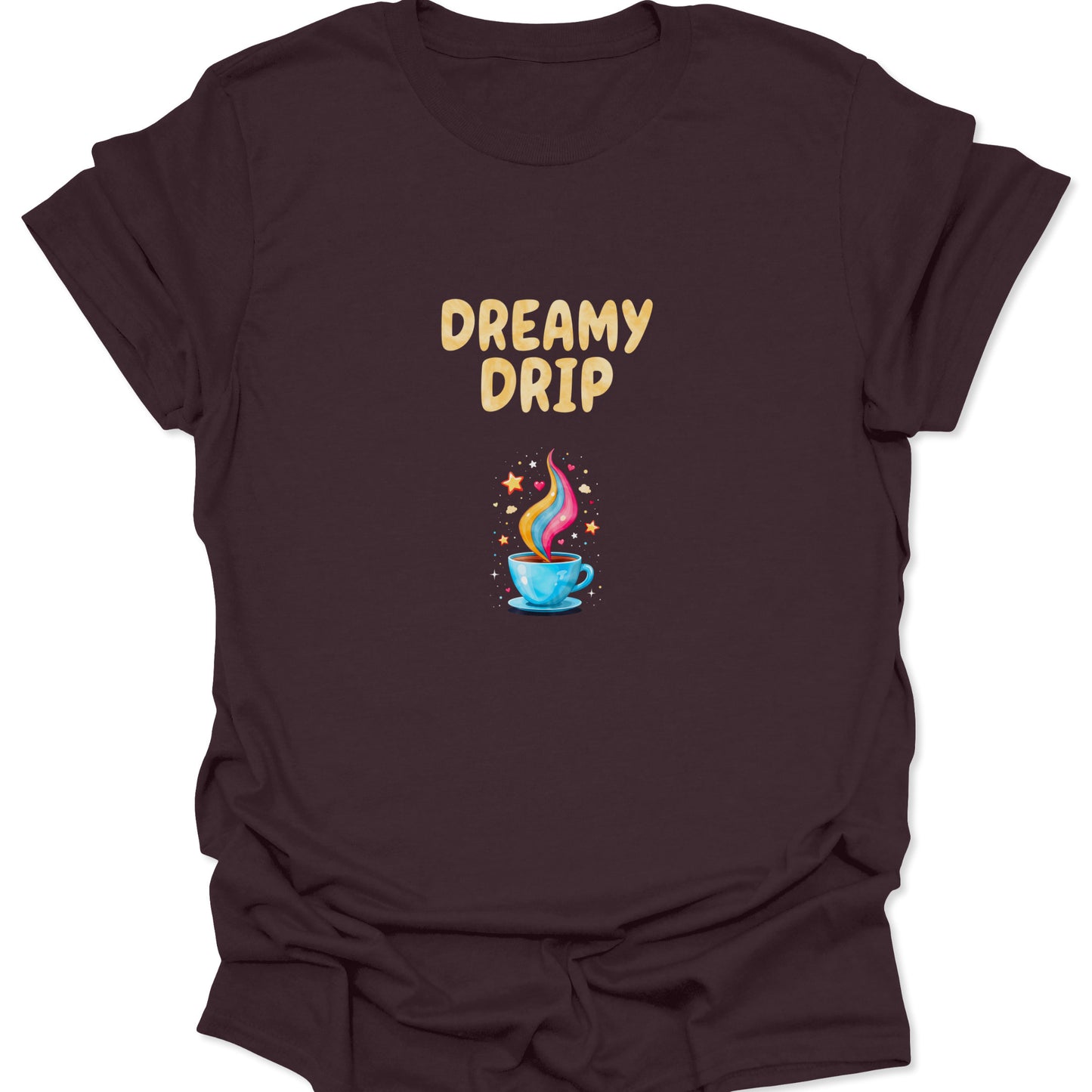 DREAMY DRIP graphic featuring a stylized, rainbow-steam coffee cup with small hearts and stars on a rich, dark brown apparel background.