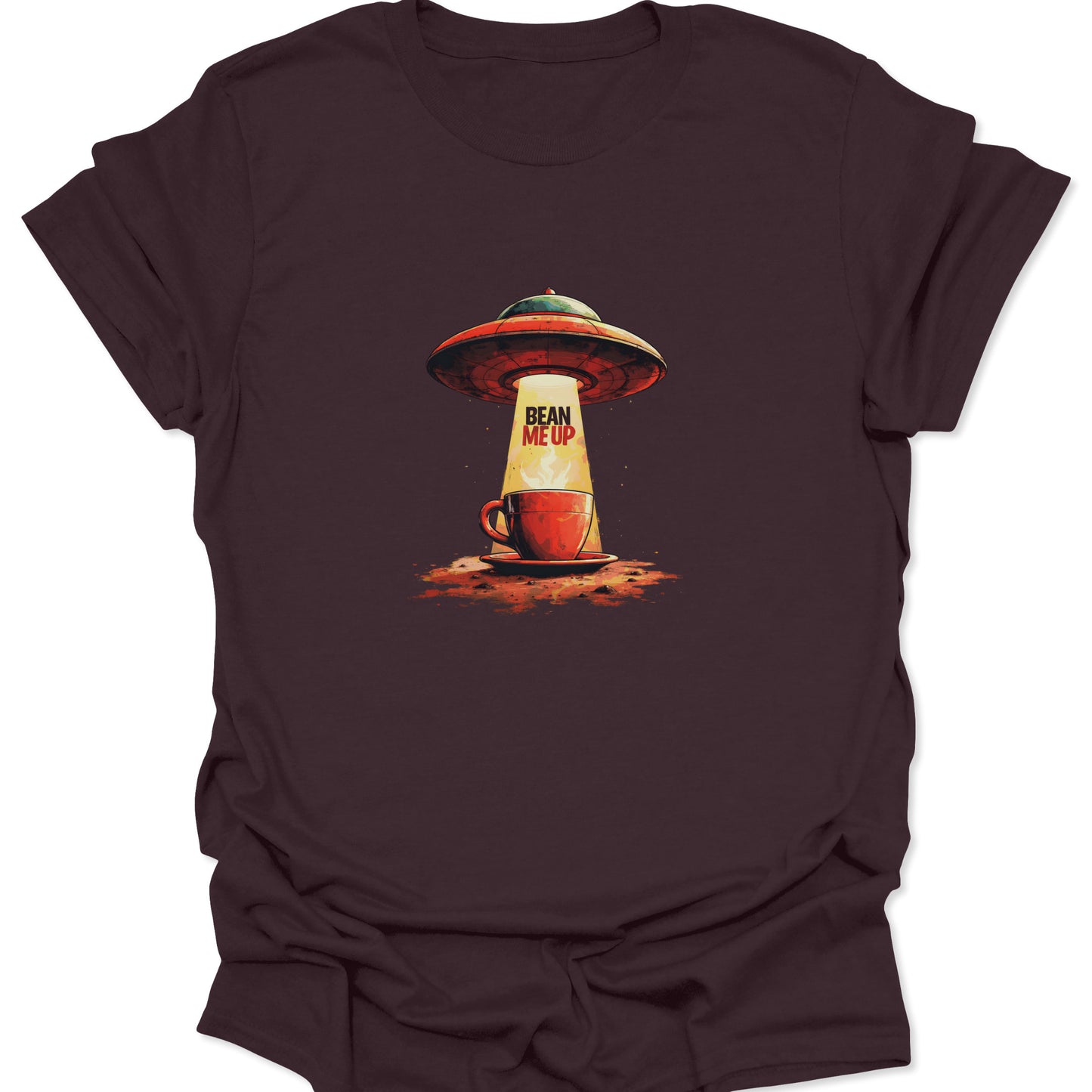 Dark brown t-shirt with a vintage-style graphic of a UFO abducting a coffee mug with the text "Bean Me Up" in the sci-fi beam.