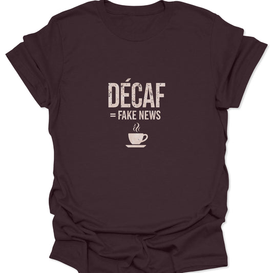 Rich brown shirt featuring a distressed, light cream graphic stating "DÉCAF = FAKE NEWS" centered above a minimalist coffee cup icon.