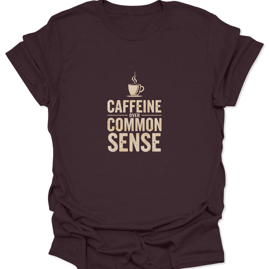 Dark brown tee showing vintage cream typography "Caffeine Over Common Sense" and steaming mug graphic.