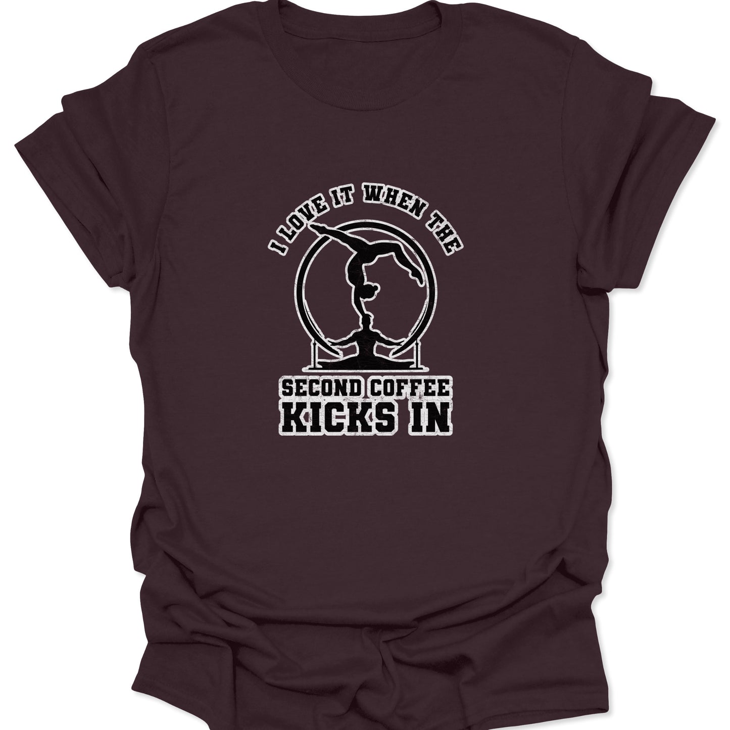A dark chocolate brown t-shirt with a vintage-style white print of a gymnastics ring balance and coffee-themed humor text.