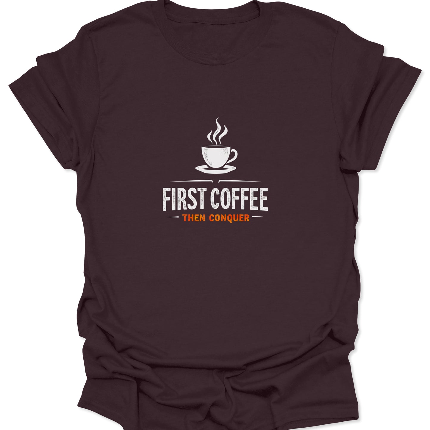 Motivational graphic t-shirt with a steaming coffee cup design and "First Coffee Then Conquer" text printed in white and orange on a rich, dark chocolate brown material.