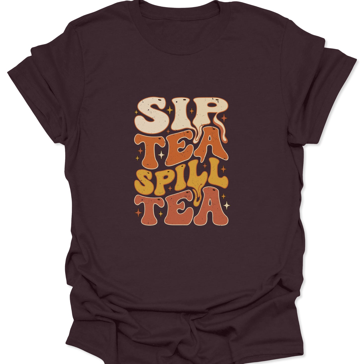 Graphic t-shirt on a dark chocolate brown fabric showing the "Sip Tea Spill Tea" design with warm earth-toned typography and vintage star accents.