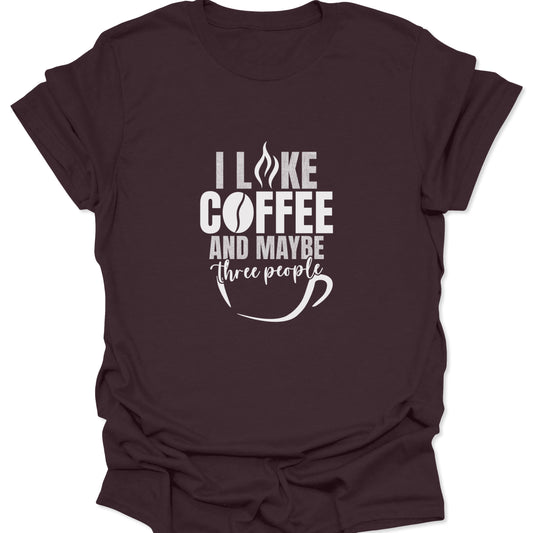 A dark chocolate brown graphic tee featuring white bold text that reads "I LIKE COFFEE AND MAYBE THREE PEOPLE" with a coffee bean and cup icon.