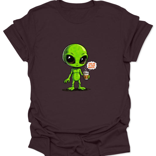 Close-up of a chibi-style green alien graphic holding a coffee cup on a rich dark chocolate brown t-shirt. Focus on bright, contrasting colors of the graphic.
