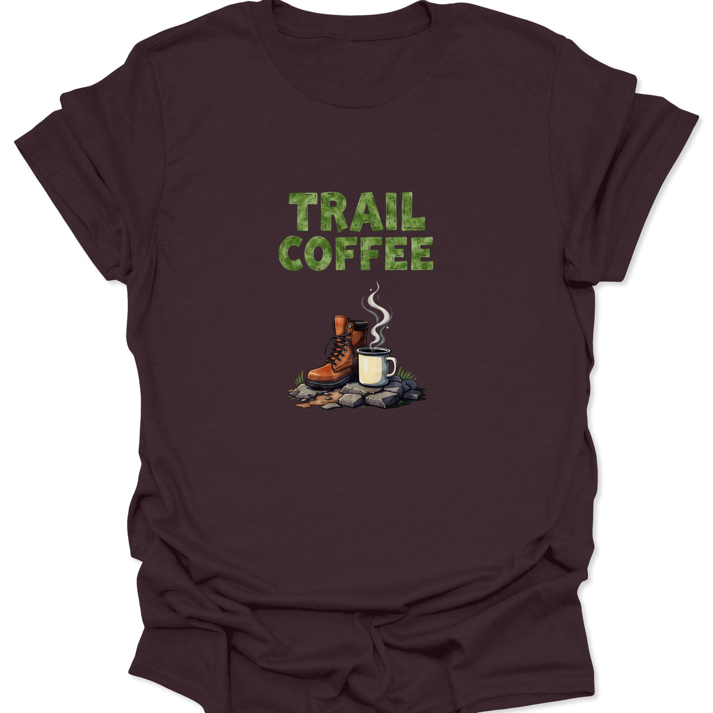 Deep brown shirt featuring the green TRAIL COFFEE text and a realistic illustration of a hiking boot and hot coffee cup on a rocky, moss-covered ground.