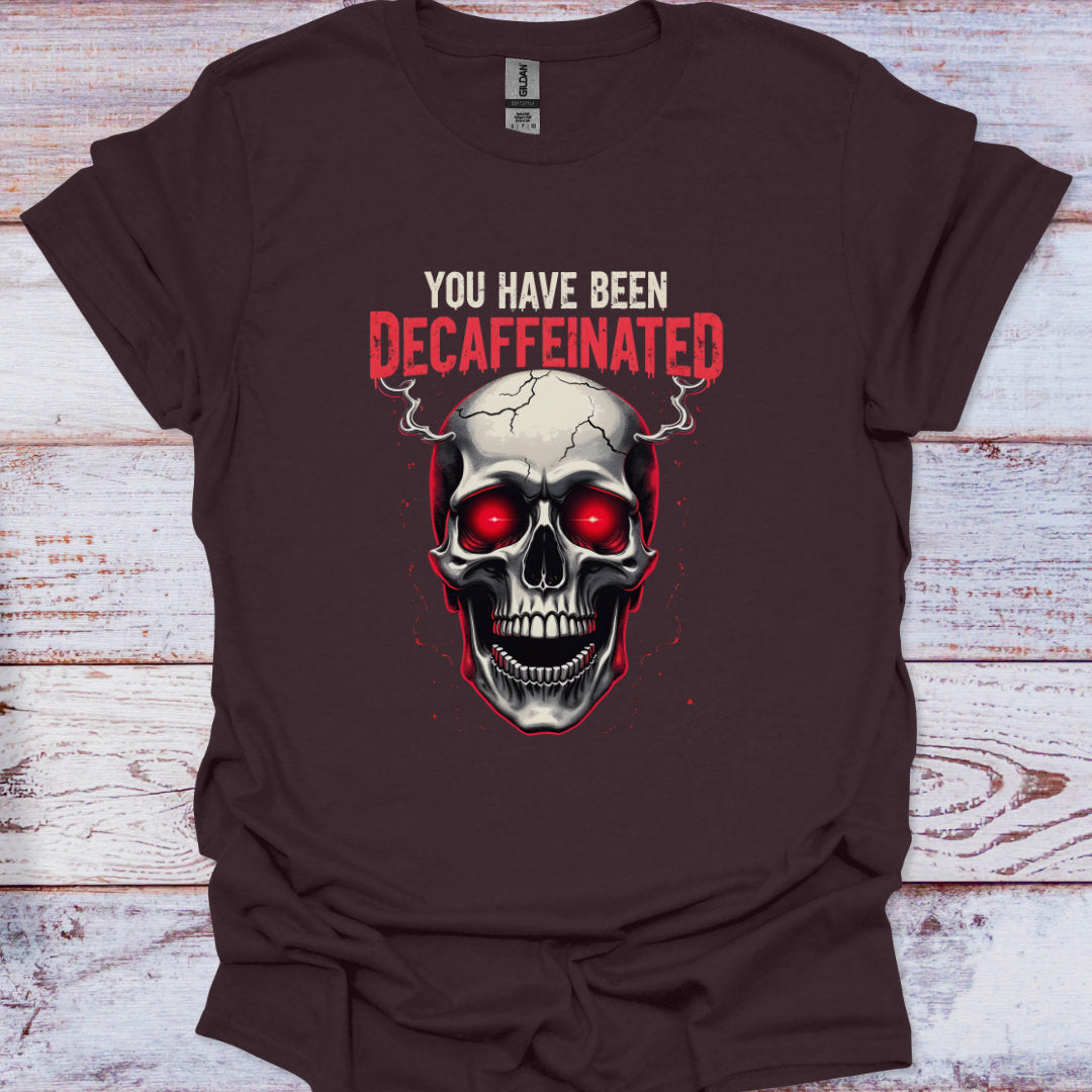 Brown t-shirt with a skull graphic and text 'You have been decaffeinated' on a wooden surface