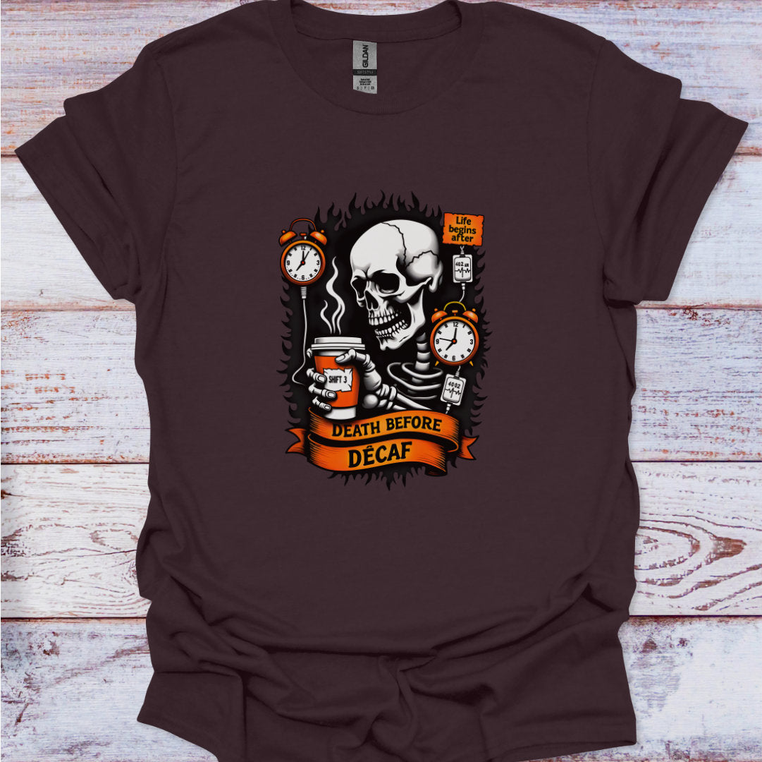 Brown t-shirt with a skeleton holding a coffee cup and text 'Death Before Decaf' on a wooden surface.