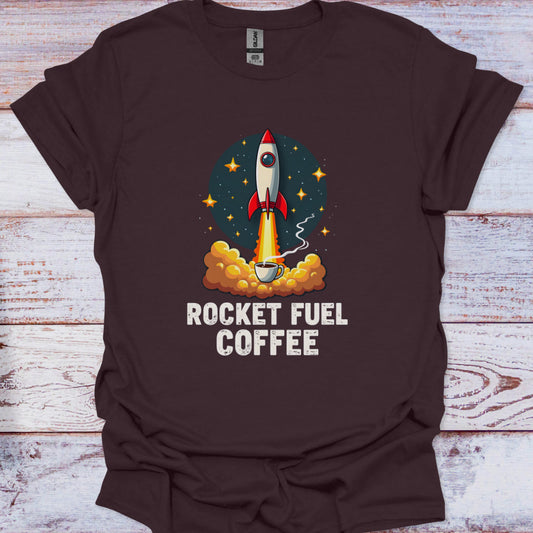 Brown t-shirt with a graphic of a rocket and 'Rocket Fuel Coffee' text on a wooden surface