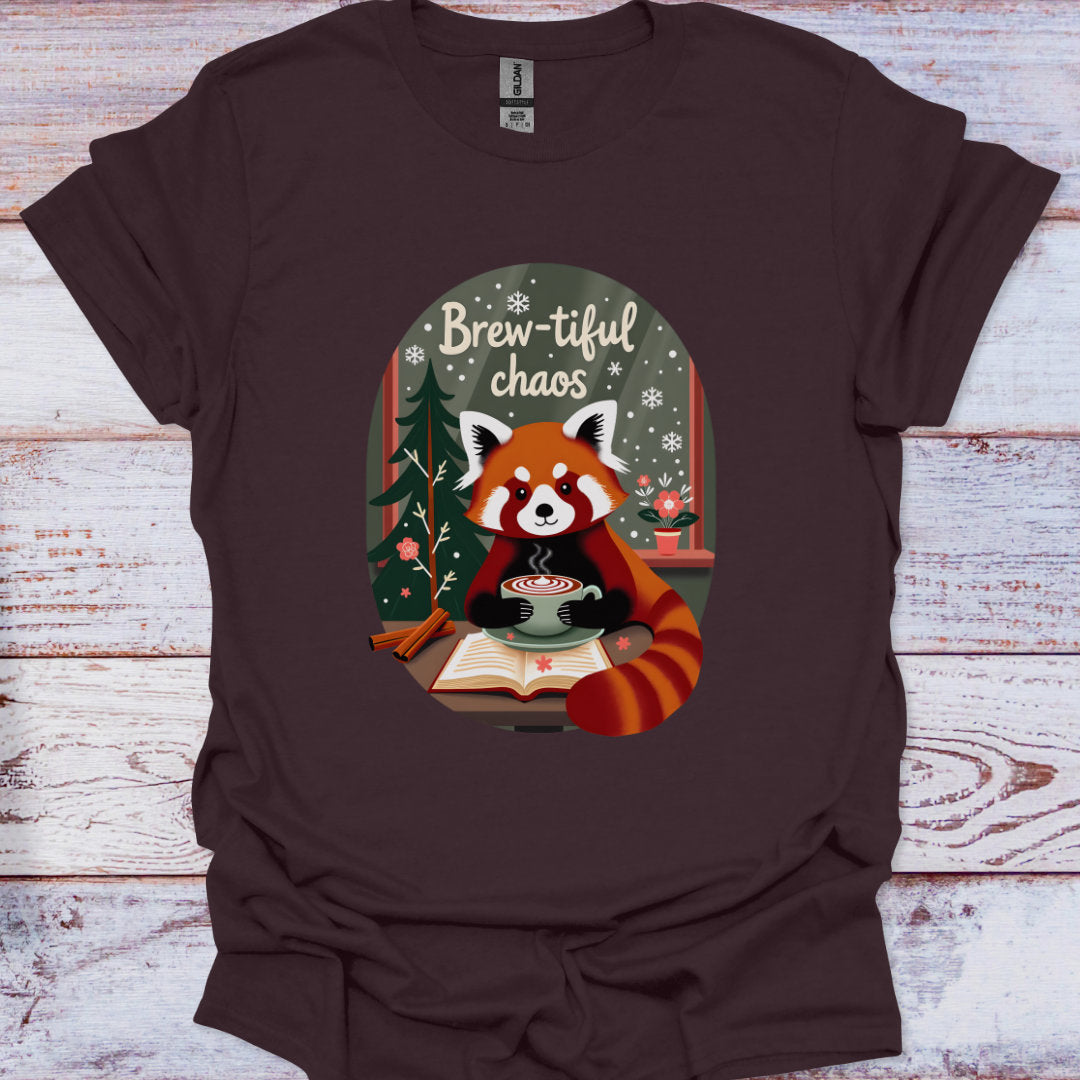 Brown t-shirt with a red panda holding a cup of coffee and the text 'Brew-tiful chaos' on a wooden background