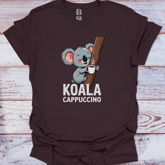 Brown t-shirt with a koala holding a coffee cup graphic and 'KOALA CAPPUCCINO' text on a wooden surface.