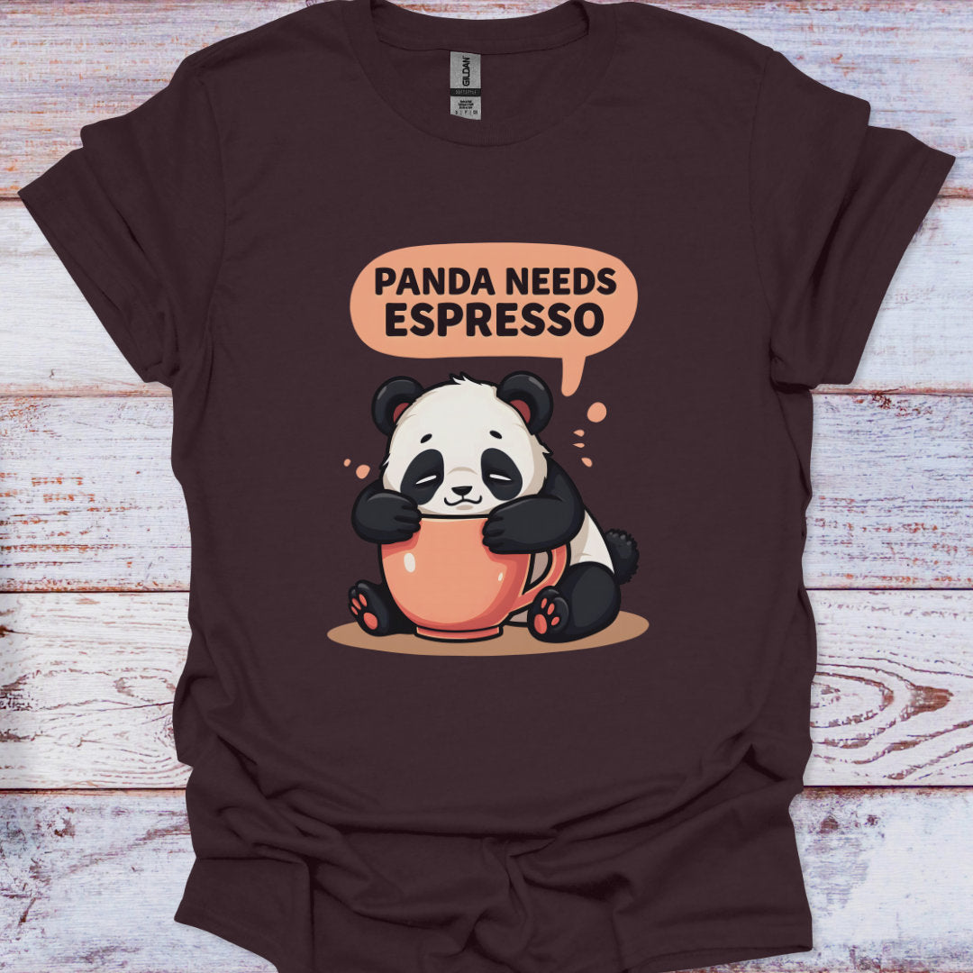 Brown t-shirt with a panda holding an espresso cup and speech bubble saying 'Panda Needs Espresso' on a wooden surface.